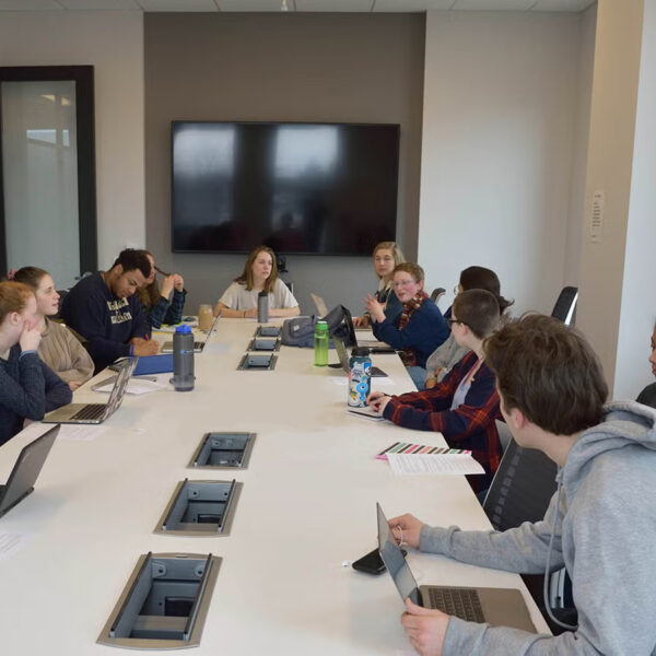 students collaborating around an office table