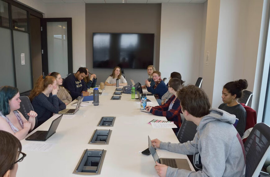 students collaborating around an office table